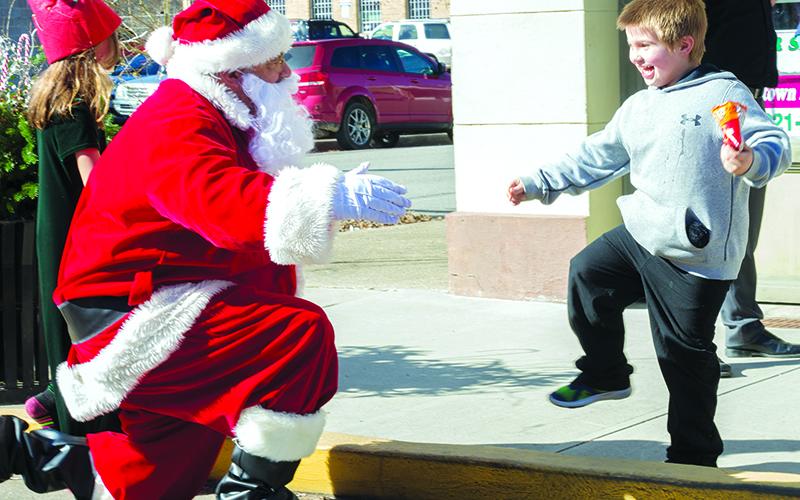 A child enjoys time with Santa during last year’s event.