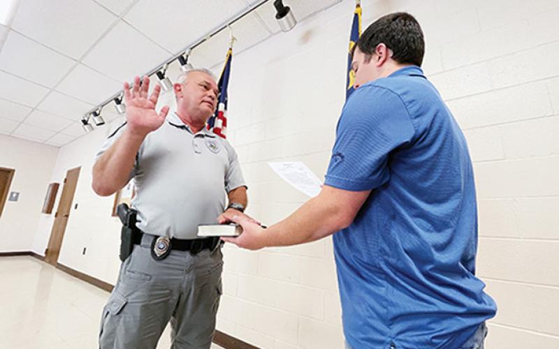 Randy Foster/editor@cherokeescout.com Andrews Interim Police Chief David Southards (left) is administered the oath of office by Town Clerk Ethan McCubbin at the facilities building Friday.